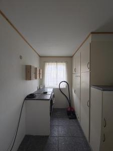 a small kitchen with a stove and a window at Glentevej 4 in Ringkøbing +17 photos