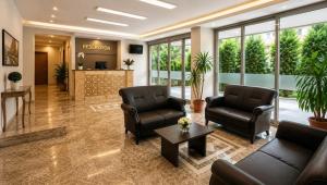 a lobby of a hospital with two chairs and a table at Palm Beach Hotel in Silifke