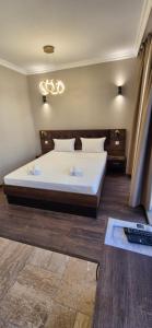 a bedroom with a large white bed and a table at MitProt Panorama Bay 2 Luks Studio 170 in Sveti Vlas