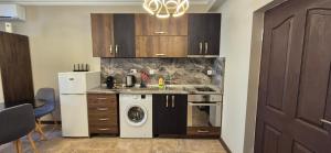 a kitchen with a sink and a washing machine at MitProt Panorama Bay 2 Luks Studio 170 in Sveti Vlas