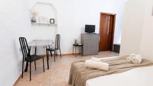 a room with a bed and a table and chairs at Casa Olmedina in Olmedo
