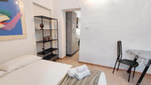 a bedroom with a bed and a chair and a table at Casa Olmedina in Olmedo
