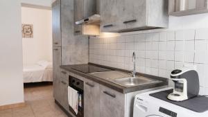 a small kitchen with a sink and a dishwasher at Casa Olmedina in Olmedo