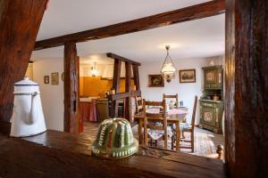 a kitchen and living room with a table and a dining room at voyage en Alsace chez Gaby in Hunawihr
