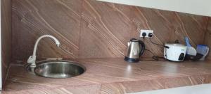 a kitchen counter with a sink and a coffee maker at Velora Resort in Anuradhapura +26 photos
