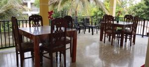 a group of tables and chairs in a restaurant at Velora Resort in Anuradhapura