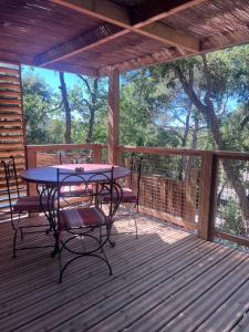 a patio with a table and chairs on a deck at Chalet Cannelle Spa camping Buffalo Hacienda in La Seyne-sur-Mer