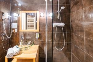 a bathroom with a shower with a glass sink at Hôtel De La Couronne in Riquewihr +52 photos
