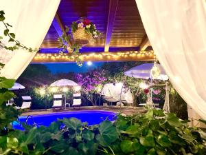 a patio with a pool with lights and plants at Mirella Charming in Alberobello +81 photos