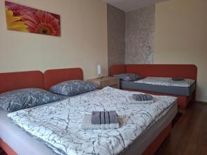 a bedroom with two beds in a room with avertisement at Apartments 17 - 23 AD Kamzík in Donovaly