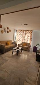 a living room with two couches and a coffee table at Piso Tamaragua in Arrecife