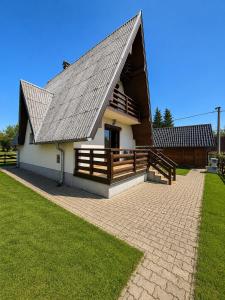 a large white building with a gambrel roof at Zlatibor week house in Palisat