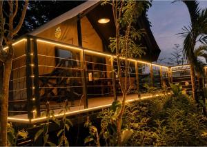 a building with lights on the side of it at The Playground in Baras +2 photos