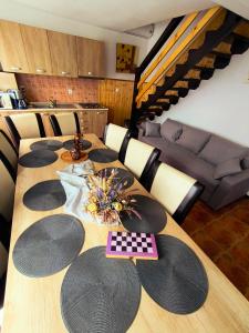 a dining room table with black hats and a couch at Cabana Geta&Mircea in Beclean +12 photos