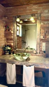 a wooden counter with a sink and a mirror at Vējavas in Svettsiyems +70 photos