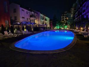a large blue swimming pool at night at MitProt Panorama Bay 2 Luks Studio 170 in Sveti Vlas