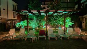 a group of chairs sitting under a gazebo at night at MitProt Panorama Bay 2 Luks Studio 170 in Sveti Vlas
