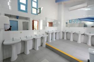 a bathroom with a row of sinks and mirrors at HolaCamp Aínsa in Aínsa