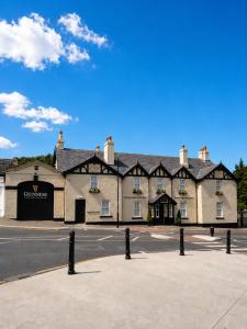 a large building on the side of a street at Powerscourt Arms Hotel in Enniskerry +20 photos