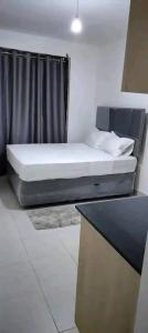 a bed in a room with a black curtain at Romantic Cage in Rungiri