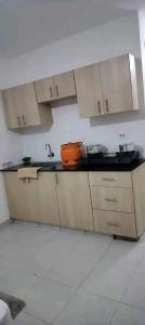a kitchen with white cabinets and a sink at Romantic Cage in Rungiri