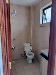 a bathroom with a toilet and a sink at Romantic Cage in Rungiri