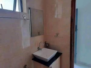 a bathroom with a sink and a mirror at Romantic Cage in Rungiri