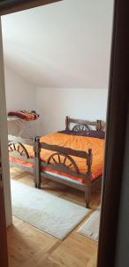 ajar view of a bedroom with a wooden bed at Villa Natalija in Andrijevica