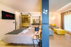 a hotel room with a bed and a living room at "Lomà" - Aosta Valley EcoResort in Champdepraz