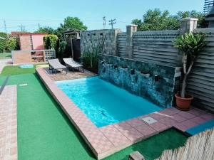 a swimming pool in the backyard of a house at Portofino Villa in Costinesti