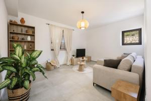 a living room with a couch and a plant at Seafront Villa in Kornati Private Terrace and Direct Beach Access in Kornati