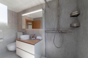 a bathroom with a shower with a toilet and a sink at Bruno in Unterwasser +22 photos