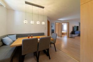 a dining room and living room with a table and chairs at Bruno in Unterwasser