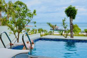 a child playing in the swimming pool at a resort at Xanadu International Resort in Koh Rong Sanloem