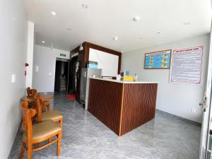 a bar in a room with chairs and a counter at Như Ý Hotel Hà Giang in Ha Giang +40 photos