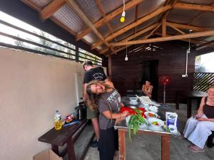 a woman is standing in front of a table with food at Surf and stay A- Bay in Arugam Bay +16 photos