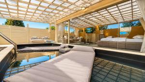 a room with two beds and a swimming pool at Liberty spa & suites - שלוש סוויטות ושתי ווילות מהממות עם בריכה פרטית in Manot