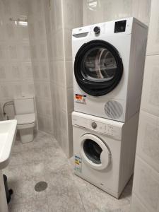 a washing machine and a washer in a bathroom at El Pozu las Ranas in Llanes +34 photos