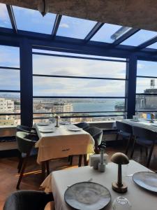 a restaurant with tables and chairs and a large window at Taksim Square Hotel in Istanbul