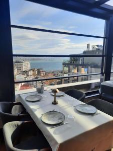 a table in a restaurant with a view of the ocean at Taksim Square Hotel in Istanbul