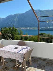 a table and chairs with a view of the water at Vila Ruška in Prčanj