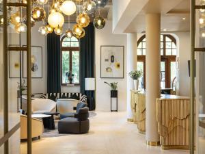a lobby of a store with chairs and tables at Rezydent Hotel Sopot - MGallery Collection in Sopot