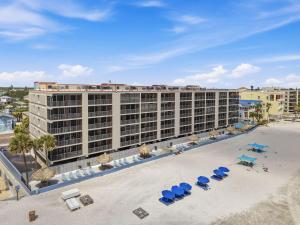 an aerial view of a hotel with chairs and beach chairs at Villa Madeira 504 - Premier in St. Pete Beach