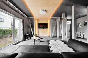 a living room with a couch and a table at The Lavenridge in Nakafurano