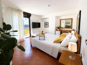 a bedroom with a large bed and a large window at Best Western Hotel Martello in Lampedusa