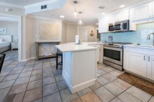a kitchen with white cabinets and a counter top at Phoenix X 609 condo in Orange Beach