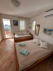 a bedroom with two beds and a living room at Casa-Poseidon in Hvar
