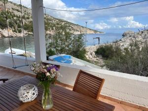 a vase of flowers sitting on a table on a balcony at Casa-Poseidon in Hvar