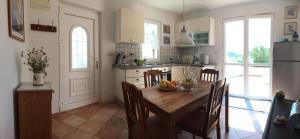 a kitchen with a wooden table with chairs and a dining room at Casa-Poseidon in Hvar