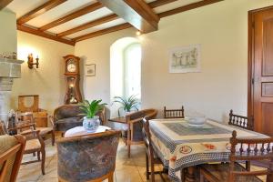 a living room with a table and chairs at Manoir De Labelangerie in Acqueville +28 photos